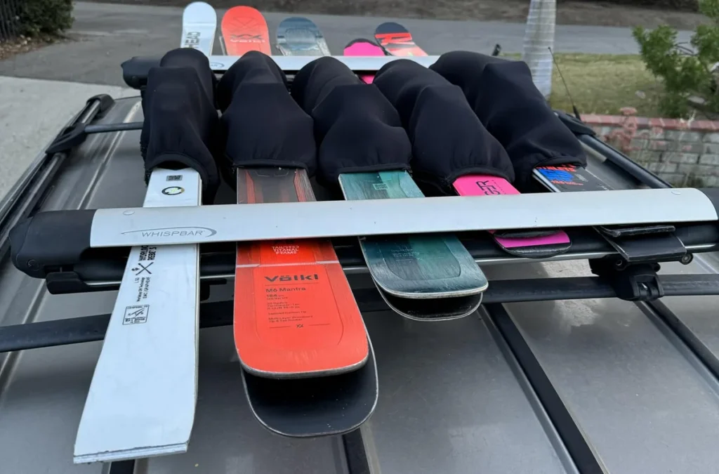 Close-up of neoprene ski binding padding covering bindings on skis stored in a rack