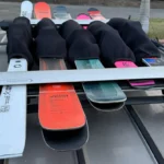 Close-up of neoprene ski binding padding covering bindings on skis stored in a rack